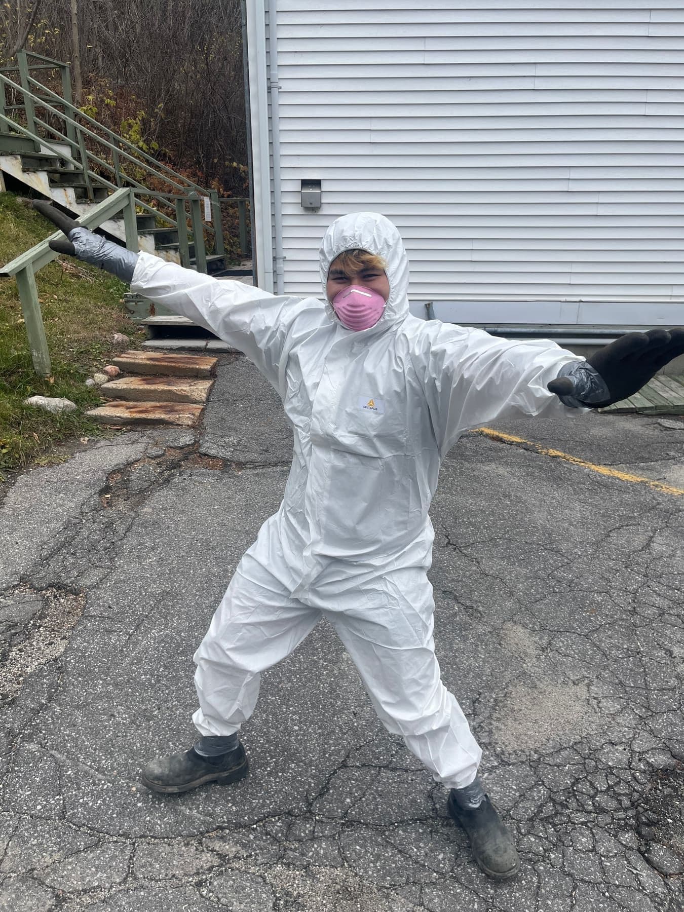 Wastely crew member in protective suit and respirator